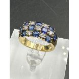 A sapphire and diamond chequerboard ring on 18ct gold mount, marked 750 Size M