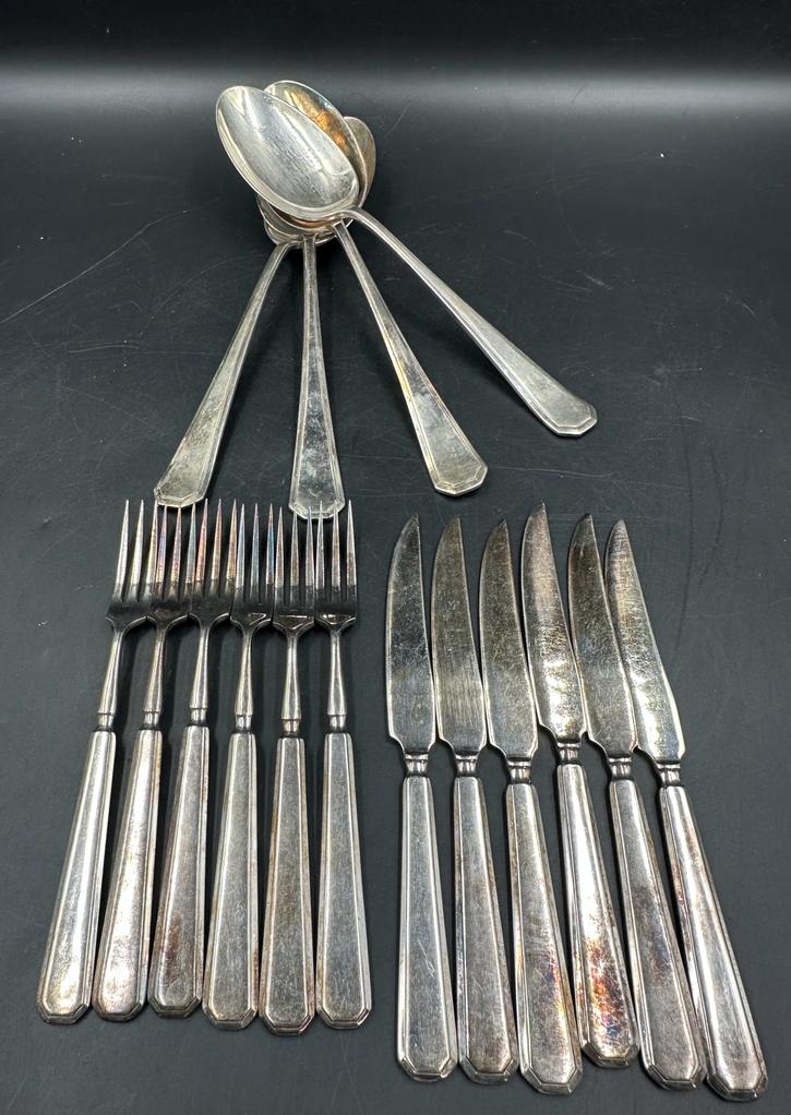A selection of quality silver plate cutlery, knives forks and serving spoons, marked A1