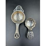 A silver tea strainer, hallmarked Birmingham 1932 by Angora Silver Plate Co Ltd along with a caddy