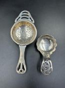A silver tea strainer, hallmarked Birmingham 1932 by Angora Silver Plate Co Ltd along with a caddy
