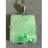 A square jade pendant on a 9ct gold necklace.