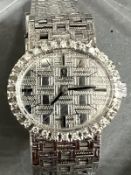 A Ladies 18ct gold and diamond Omega watch, textured white dial, black hourly makers, a 17 jewel