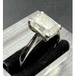 A 3.26ct emerald cut diamond which commercial White and PK3 quality, four claw platinum set on a