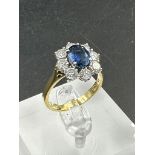 A sapphire and diamond cluster ring on an 18ct (750) shank.