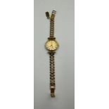 A ladies Omega De Ville bracelet watch on a hallmarked 9ct gold London 1985 bracelet. Approximate