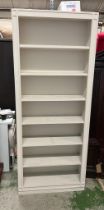 A painted open bookcase (H220cm W90cm D28cm)