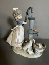 A large boxed Lladro figure of a young girl at a water pump Condition Report good condition