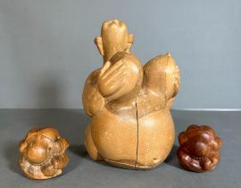 Three tribal art wooden carved figures to include two weeping monks