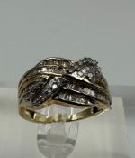 A 9ct yellow gold and diamond cross over ring with baguette style setting Size L