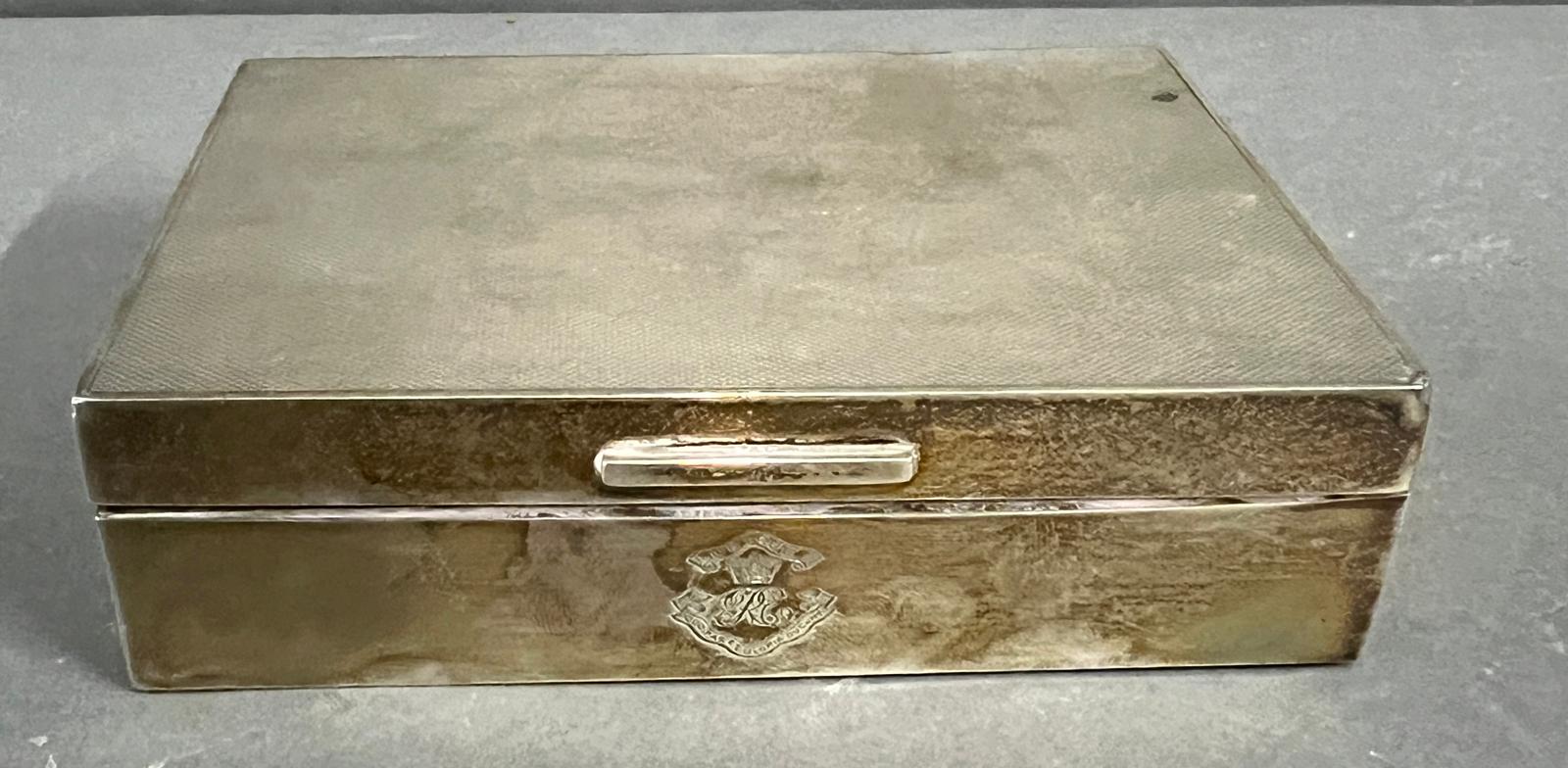 A Garrard and Co silver cigarette box with machine tooled decoration, Hallmarked for London 14cm x