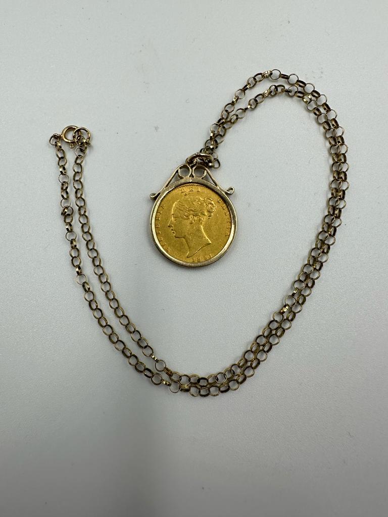 A Victorian young head, shield back half sovereign 1851 on a 9ct gold mount and necklace (