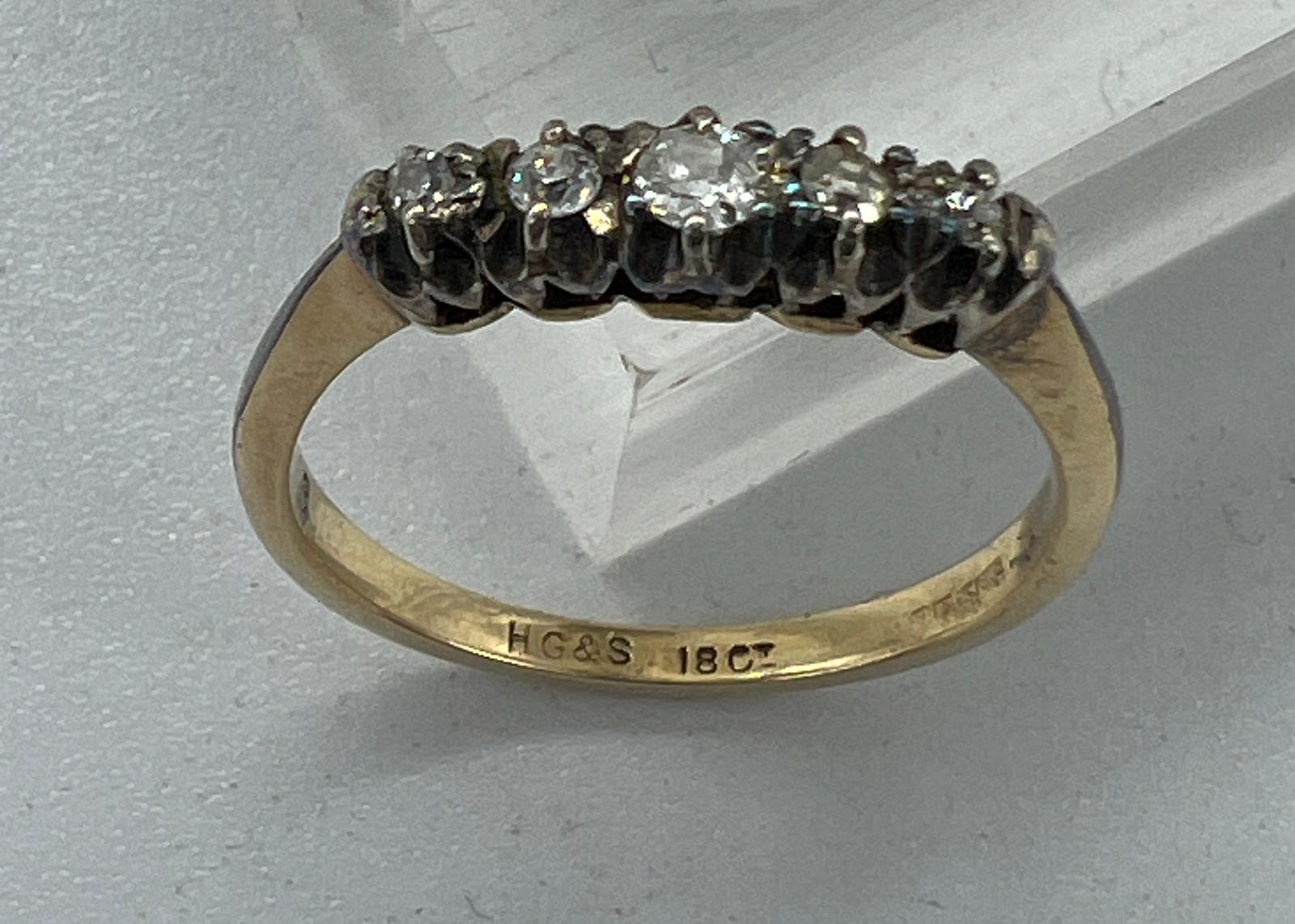 An 18ct five stone diamond ring, approximate size N
