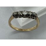 An 18ct five stone diamond ring, approximate size N