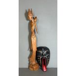 A wooden carved figure of an Indonesian woman and a tribal mask (H60cm)