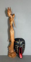 A wooden carved figure of an Indonesian woman and a tribal mask (H60cm)