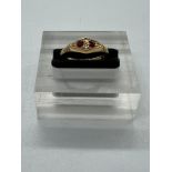 An 18ct gold antique ring with inset rubies and ornate design, approximate total weight 2.1g and