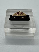 An 18ct gold antique ring with inset rubies and ornate design, approximate total weight 2.1g and