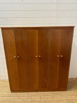 A Mid Century teak Clerical cabinet comprising of three cupboards and multiple shelves (H128cm