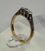 A 9ct gold and platinum three stone diamond ring, size L.