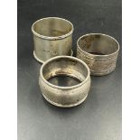 A selection of three silver hallmarked napkin rings, various hallmarks and makers. (Approximate