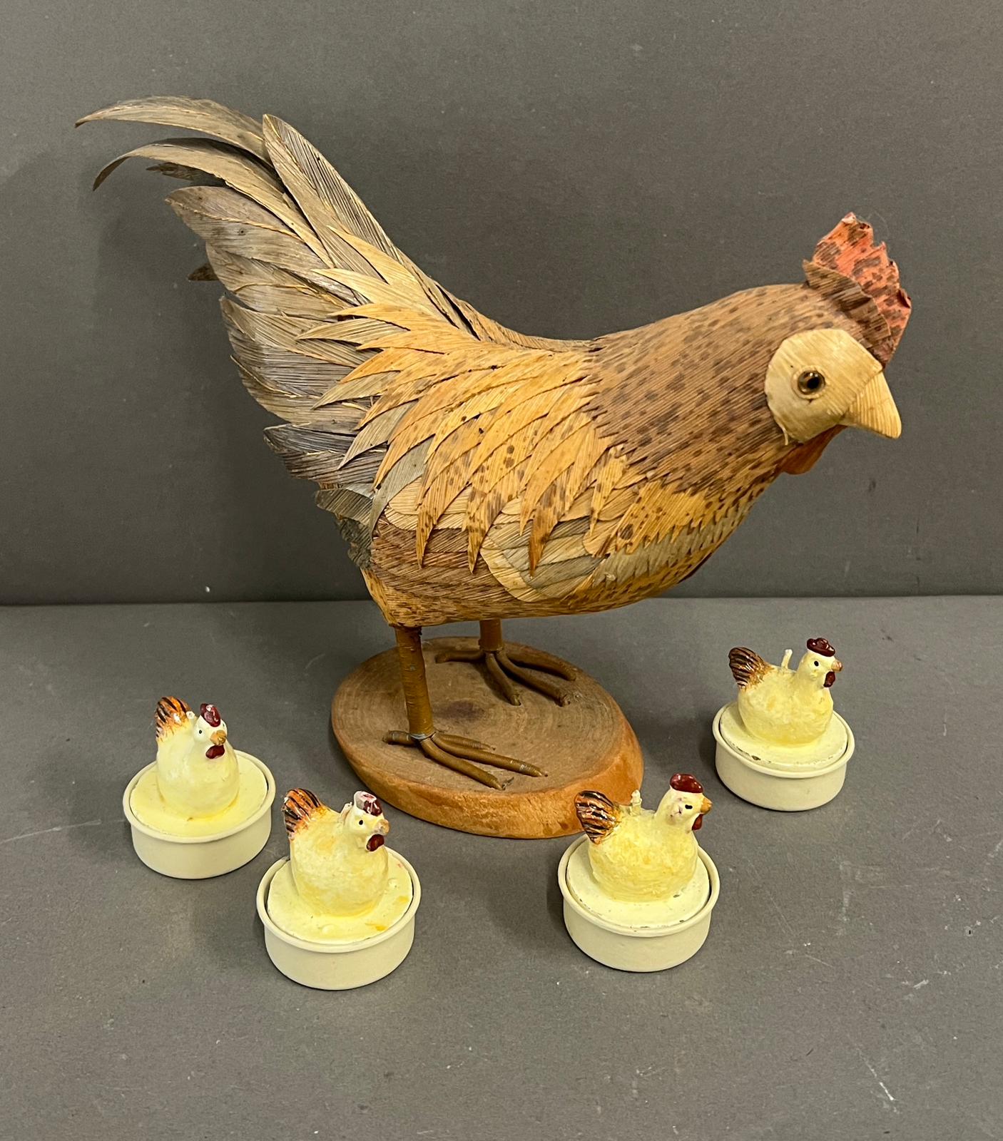 A model chicken and four tee lights in the form of chickens