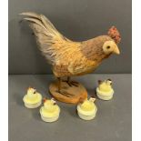 A model chicken and four tee lights in the form of chickens