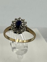 A 9ct gold ring with diamonds and central sapphire Size J