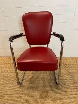 A red Art Deco style chair on chrome frame