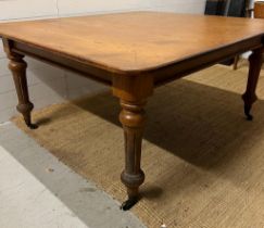 An elm dining table on turned legs (H73cm W152cm D137cm)