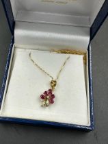 An 18ct, marked 750, chain with diamond and ruby floral themed pendant, approximate total weight 2.