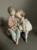 Two boxed Lladro figures, a lady with parasol and a boy and girl on bench Condition Report good