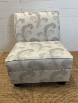 A contemporary Easy chair or bedroom chair with a dove grey feather pattern upholstery
