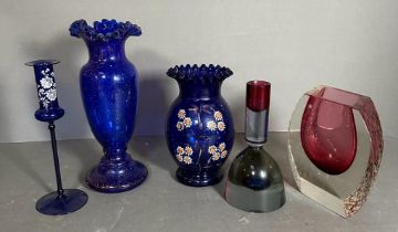 A selection of coloured glass to include candlesticks and vases