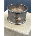 A single engraved silver napkin ring, hallmarked for Birmingham