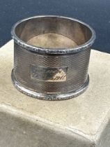 A single engraved silver napkin ring, hallmarked for Birmingham