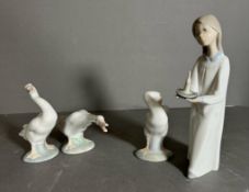 Four boxed Lladro figures. A girl with a candle and three geese