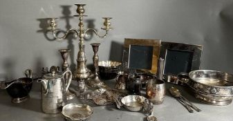 A quantity of silver plate to include saucer boats, picture frames and candle sticks