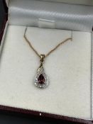 A 9ct gold necklace with a diamond and garnet pendant (Approximate total weight 2.4g