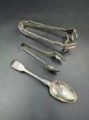A small selection of silver items two pairs of sugar tongs and a teaspoon