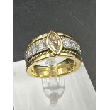 A yellow gold diamond ring with central stone and three separate diamonds to each side .Size Q