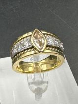 A yellow gold diamond ring with central stone and three separate diamonds to each side .Size Q