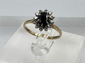 A 9ct gold sapphire and diamond ring in a daisy style, approximate size L.