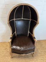 A Safavieh Couture leather Porters chair with large canopy top (H153cm W83cm D53cm)