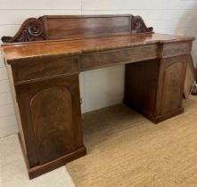 A Victorian mahogany breakfront pedestal sideboard, comprising of central drawers flanked by