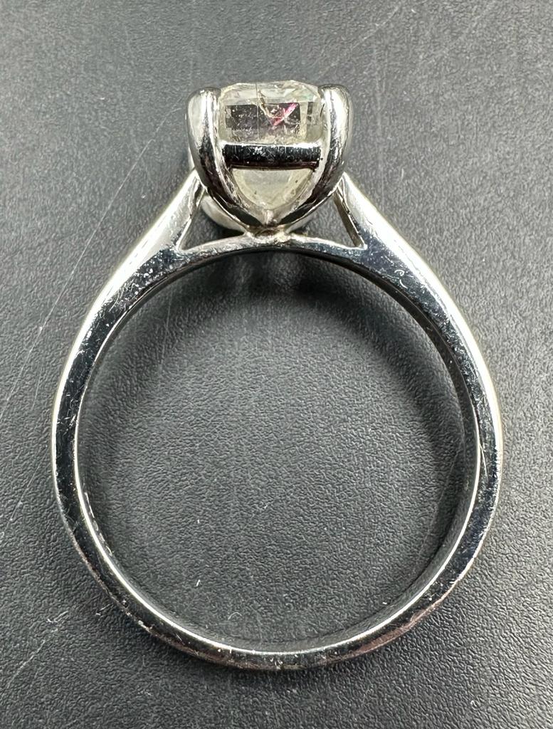 A 3.26ct emerald cut diamond which commercial White and PK3 quality, four claw platinum set on a - Image 2 of 5