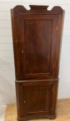 A mahogany corner cupboard with scrolling cornice (H190cm W74cm D44cm)