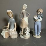 Three boxed Lladro figures, a young girl with a duck and basket, a standing girl with duck and