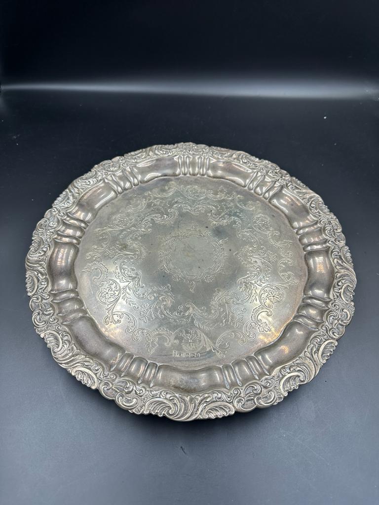 A silver tray on three feet, hallmarked for Sheffield 1909 by Joseph Rodgers & Sons