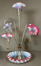 A Victorian epergne with opalescent glass with accents of pink and hanging baskets.