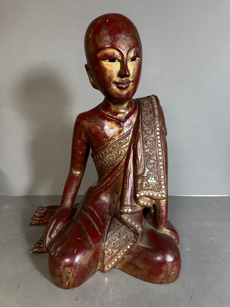 A wooden carved statue of a Mandalay monk painting in red and gold (H44cm)